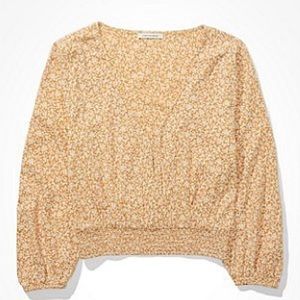 Golden yellow, floral, wrap-front blouse.